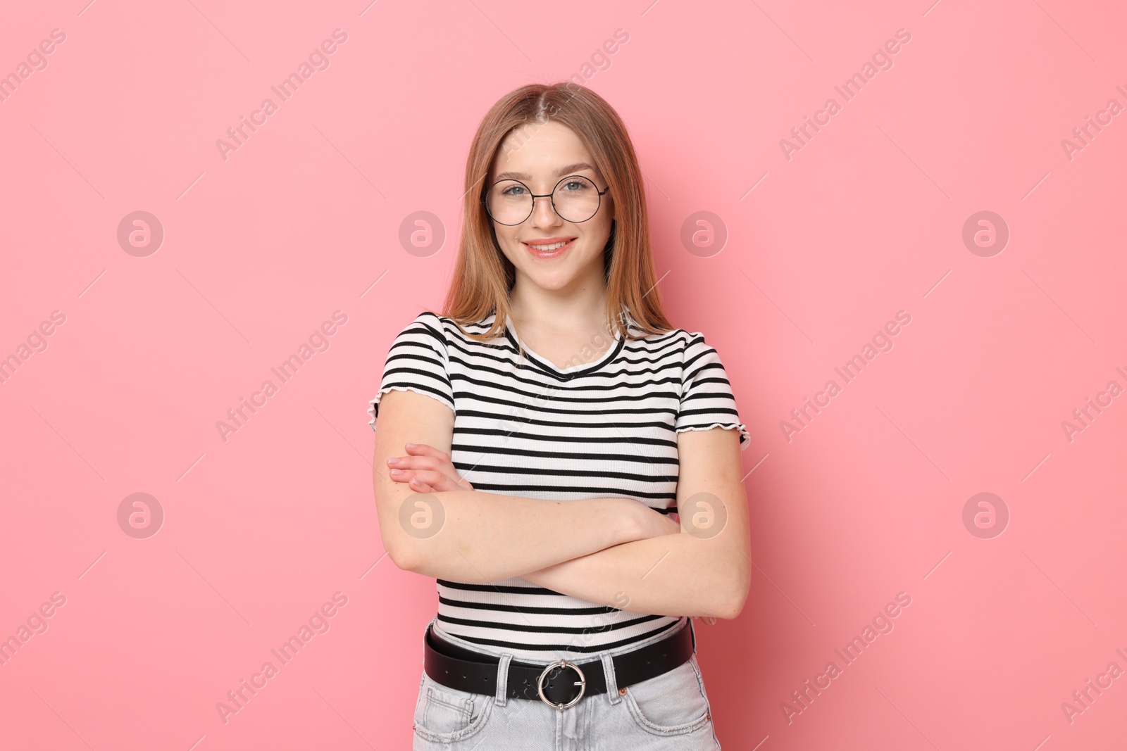 Portrait of smiling teenage girl on pink background Photo of Portrait of smiling teenage girl on pink background