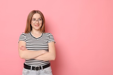 Photo of Portrait of smiling teenage girl on pink background. Space for text