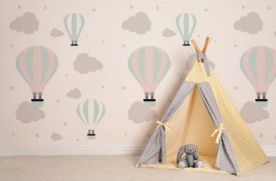 Image of Cozy children's room with play tent and cute wallpaper. Stylish playroom interior