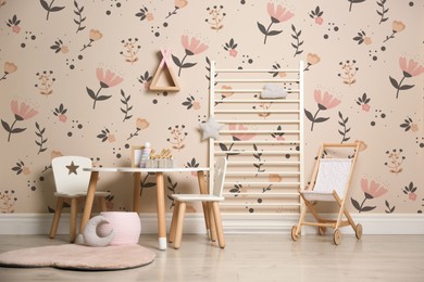 Image of Stylish playroom with toys, furniture and cute wallpaper. Children's room interior