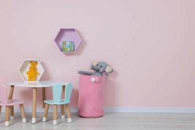 Image of Cozy playroom with cute toys and furniture. Children's room interior