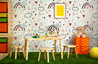 Image of Cozy playroom with toys, furniture and cute wallpaper. Stylish children's room interior