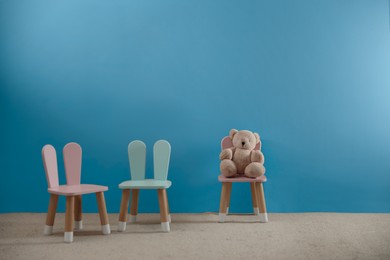 Image of Cozy playroom with toy and cute small chairs. Children's room interior