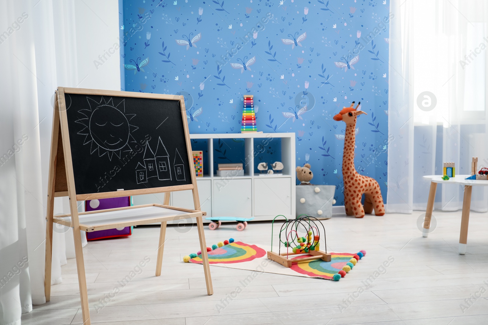 Cozy playroom with toys, furniture and cute wallpaper. Stylish children's room interior Image of Cozy playroom with toys, furniture and cute wallpaper. Stylish children's room interior
