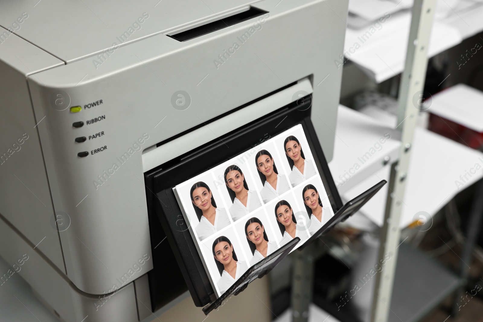 Modern printer with passport photos of woman indoors, closeup Image of Modern printer with passport photos of woman indoors, closeup