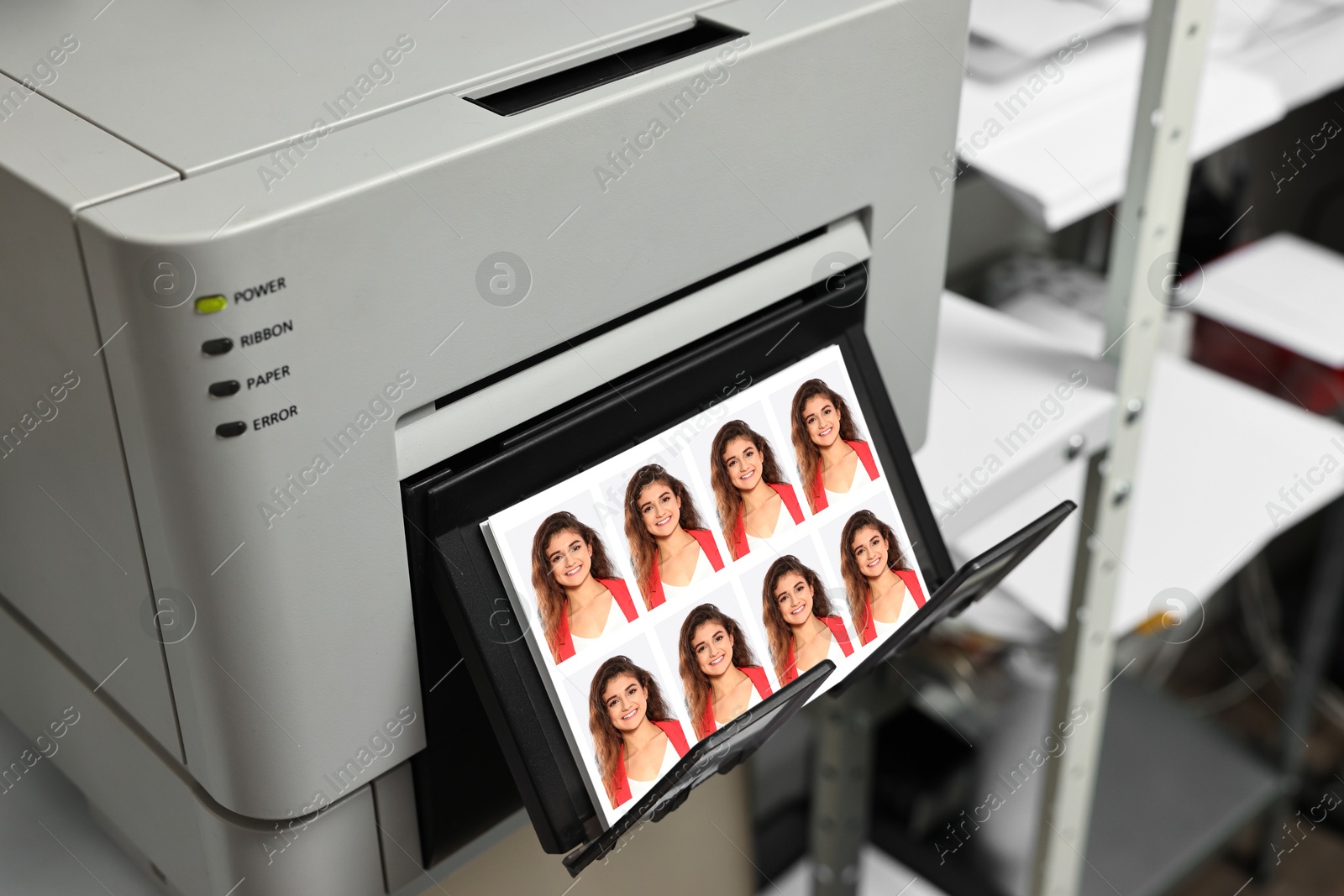 Modern printer with passport photos of woman indoors, closeup Image of Modern printer with passport photos of woman indoors, closeup