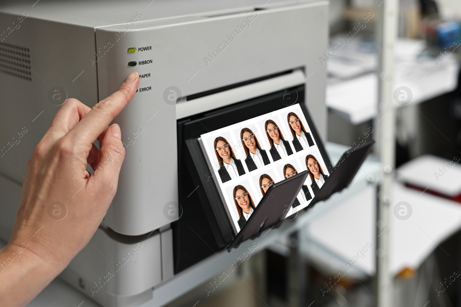 Worker using modern printer to print passport photos of woman indoors, closeup Image of Worker using modern printer to print passport photos of woman indoors, closeup