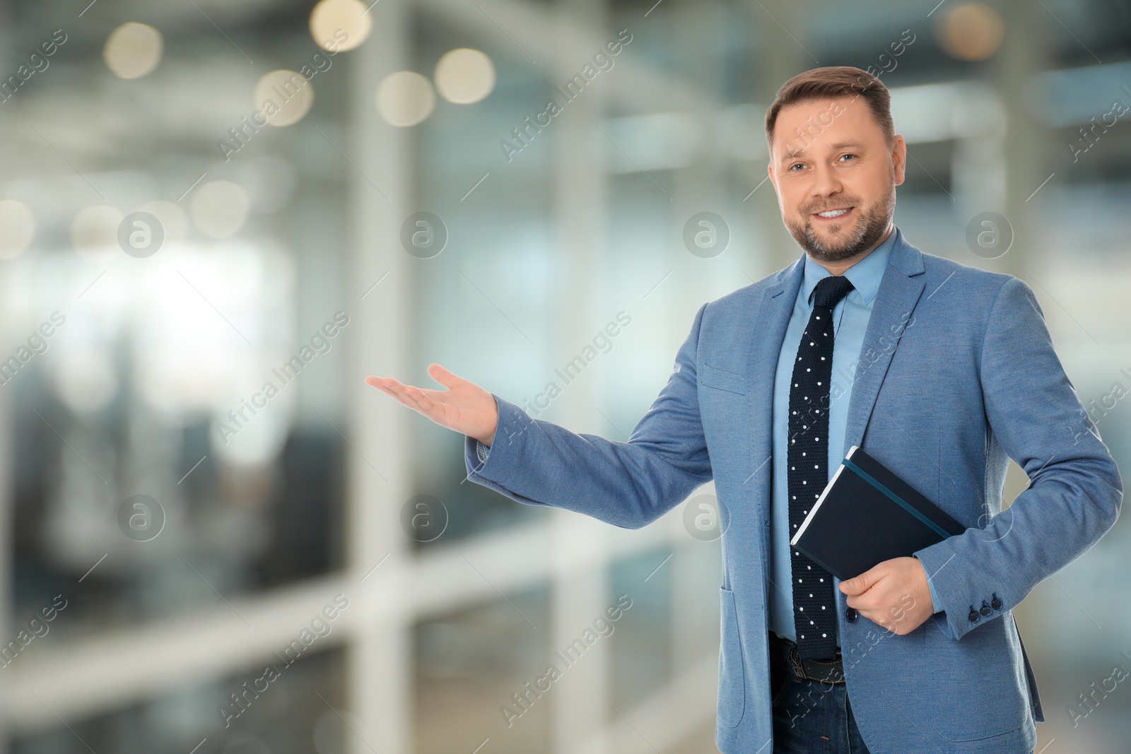 Real estate agent with notebook indoors, space for text Image of Real estate agent with notebook indoors, space for text