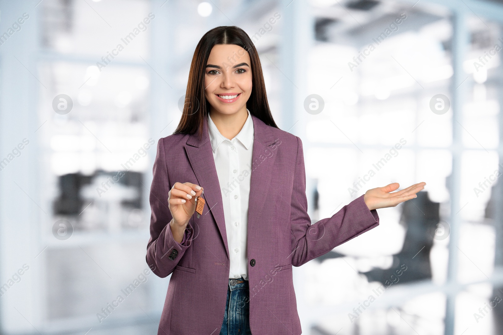 Real estate agent with house key indoors Image of Real estate agent with house key indoors