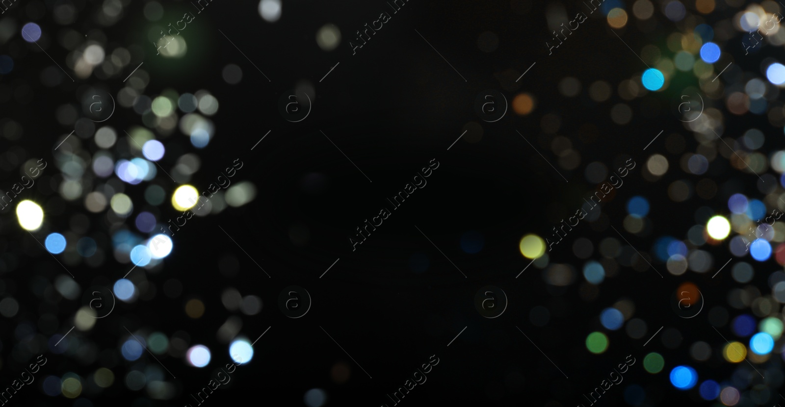 Blurred sparkling glitter on black background, bokeh. Abstract festive backdrop. Banner design with space for text Image of Blurred sparkling glitter on black background, bokeh. Abstract festive backdrop. Banner design with space for text