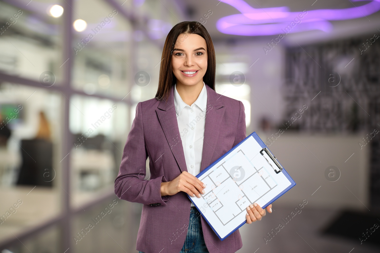 Real estate agent holding clipboard with house plan indoors Image of Real estate agent holding clipboard with house plan indoors