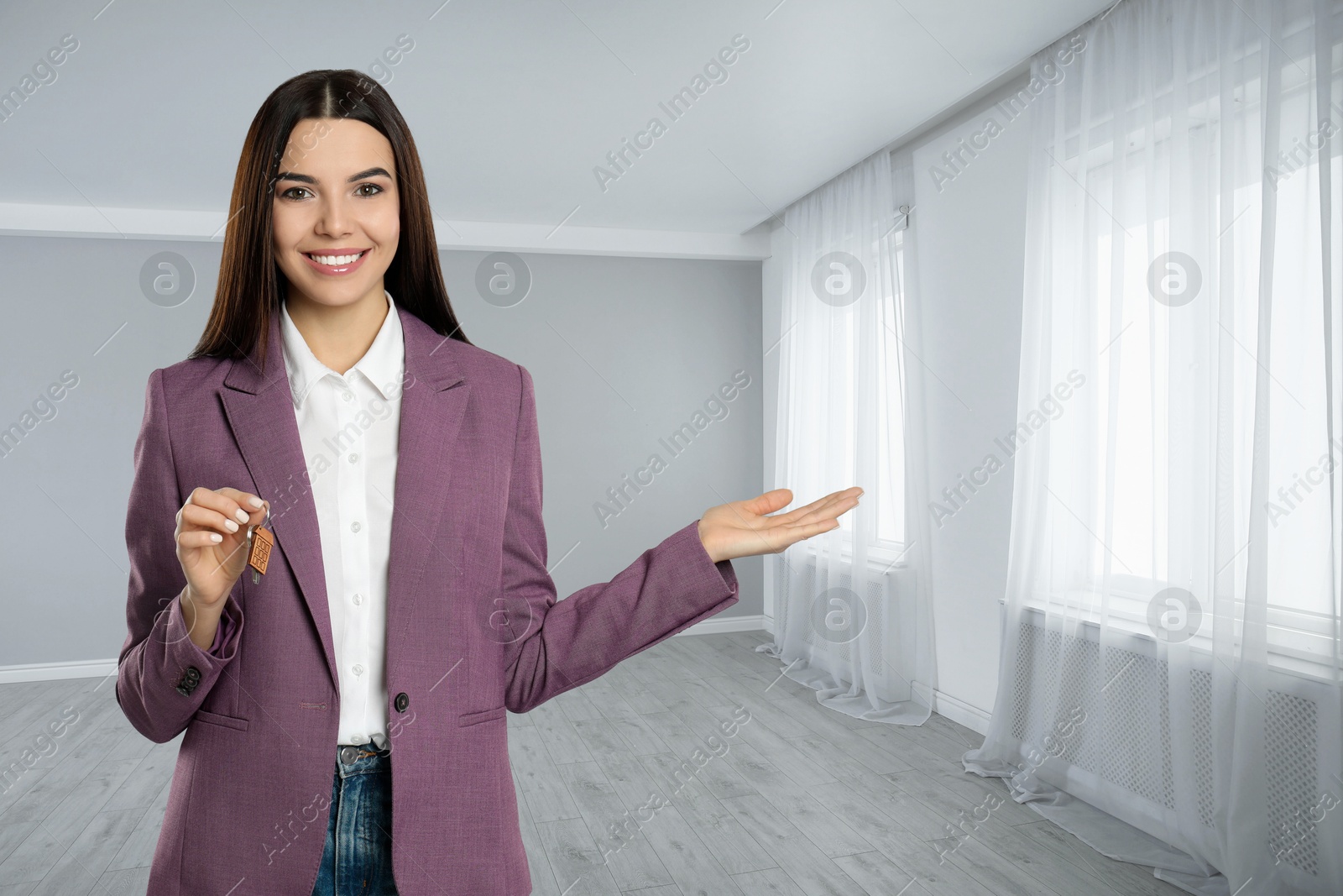 Real estate agent with house key in room Image of Real estate agent with house key in room