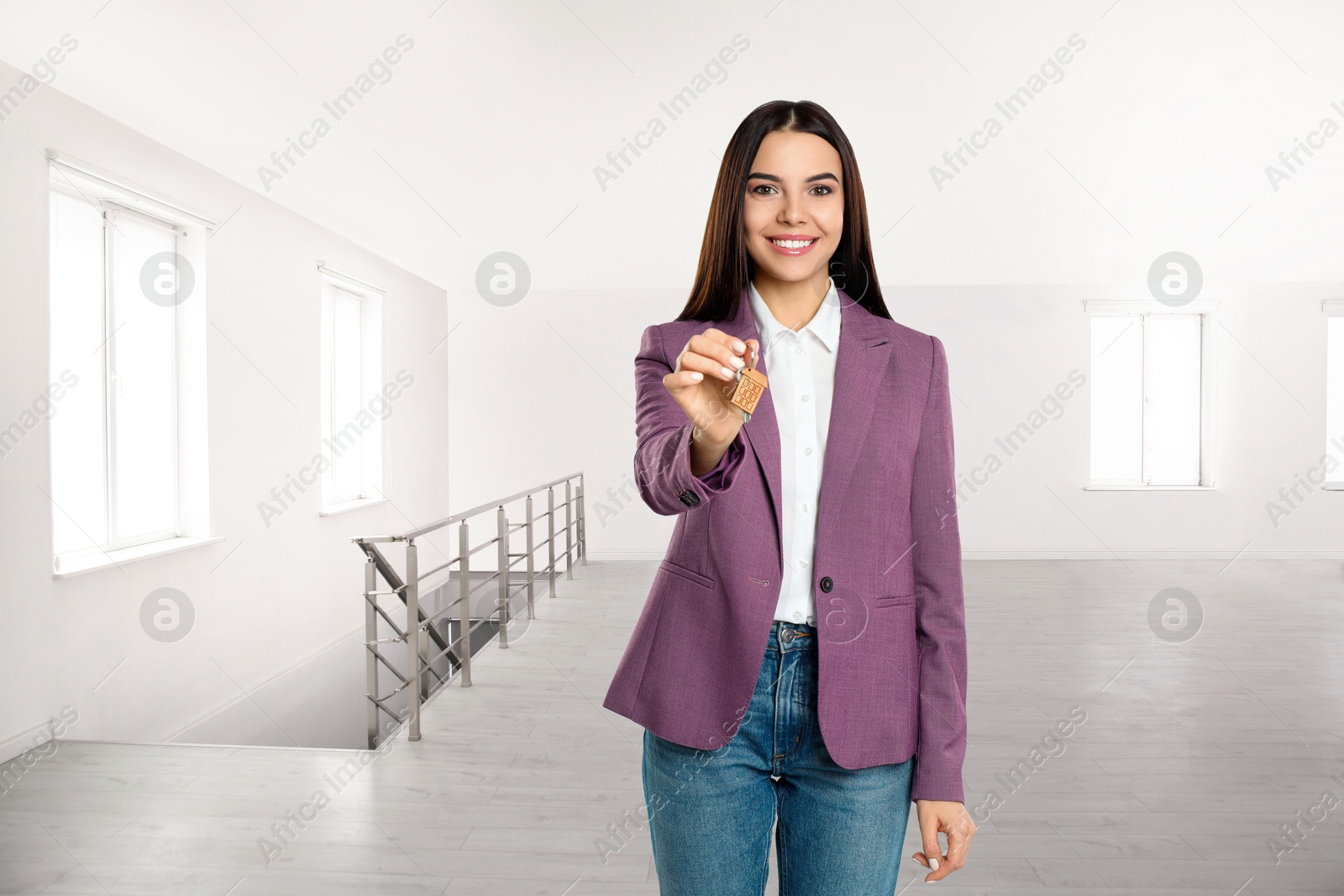 Real estate agent with house key in apartment Image of Real estate agent with house key in apartment