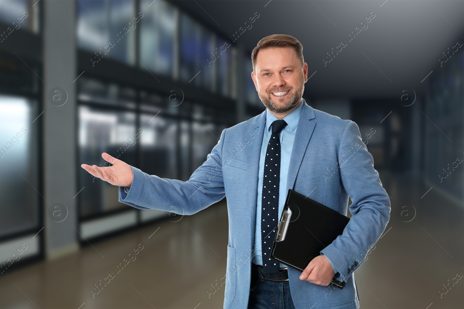 Real estate agent holding clipboard in room Image of Real estate agent holding clipboard in room