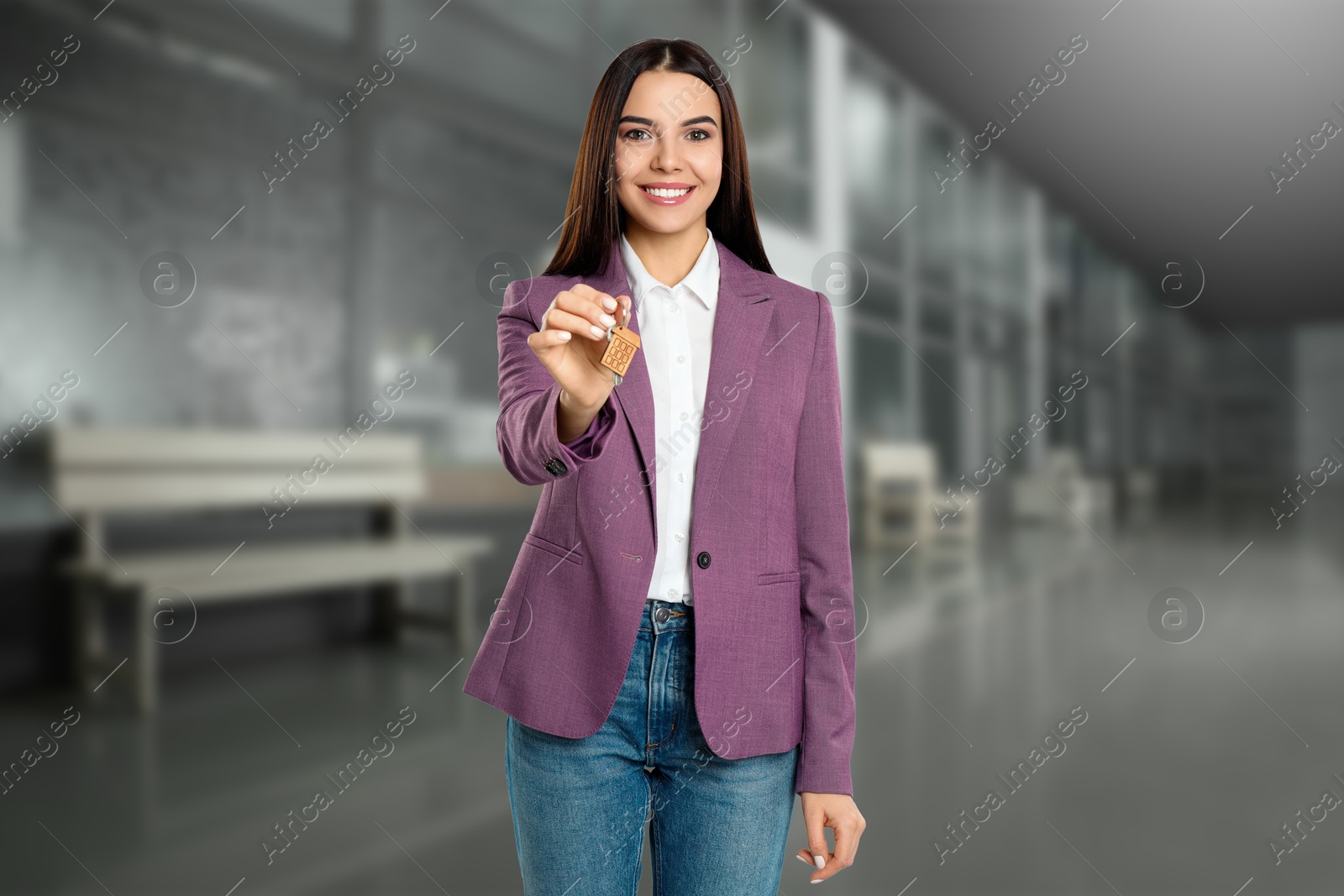 Real estate agent with house key indoors Image of Real estate agent with house key indoors