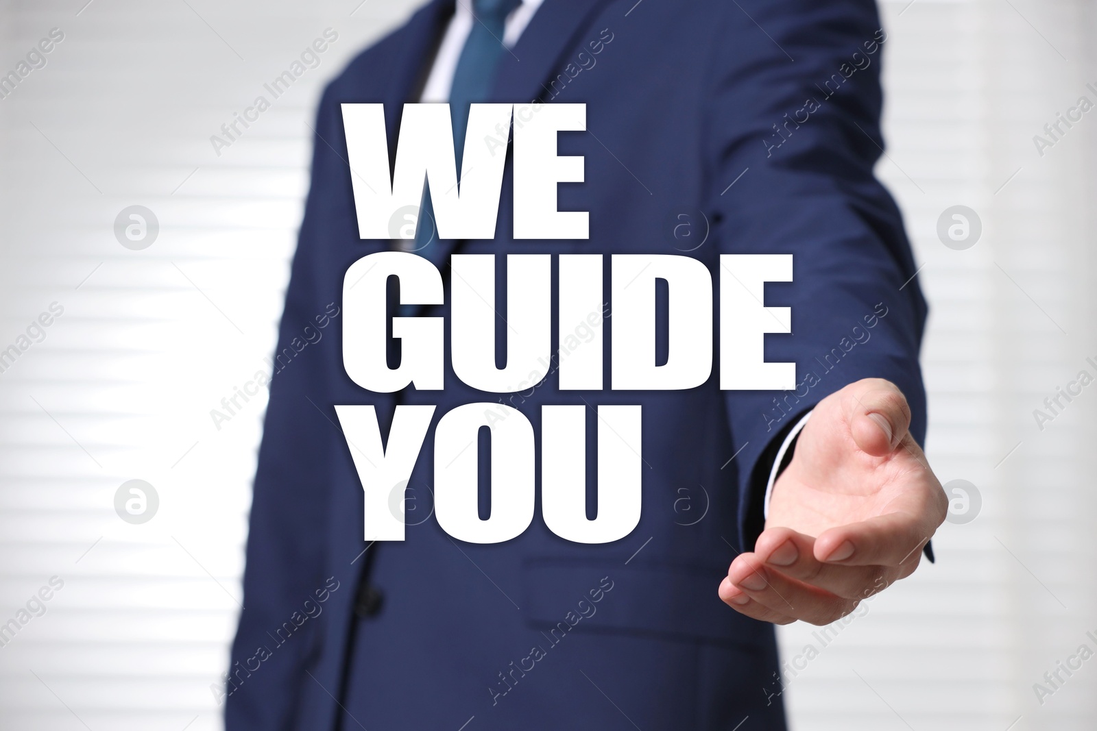 We Guide You. Businessman offering helping hand on light grey background, closeup Image of We Guide You. Businessman offering helping hand on light grey background, closeup
