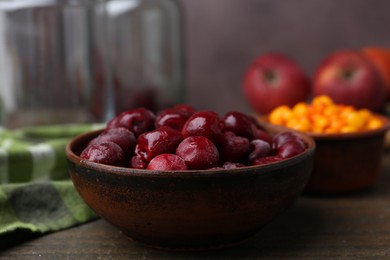 Photo of Tasty cherries and other fruits on wooden table, closeup