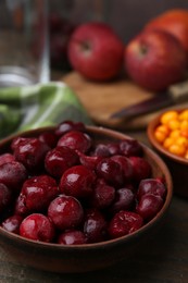 Photo of Tasty cherries and other fruits on wooden table, closeup