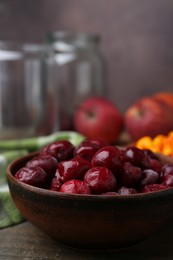 Photo of Tasty cherries, sea buckthorn berries and apples on wooden table, closeup