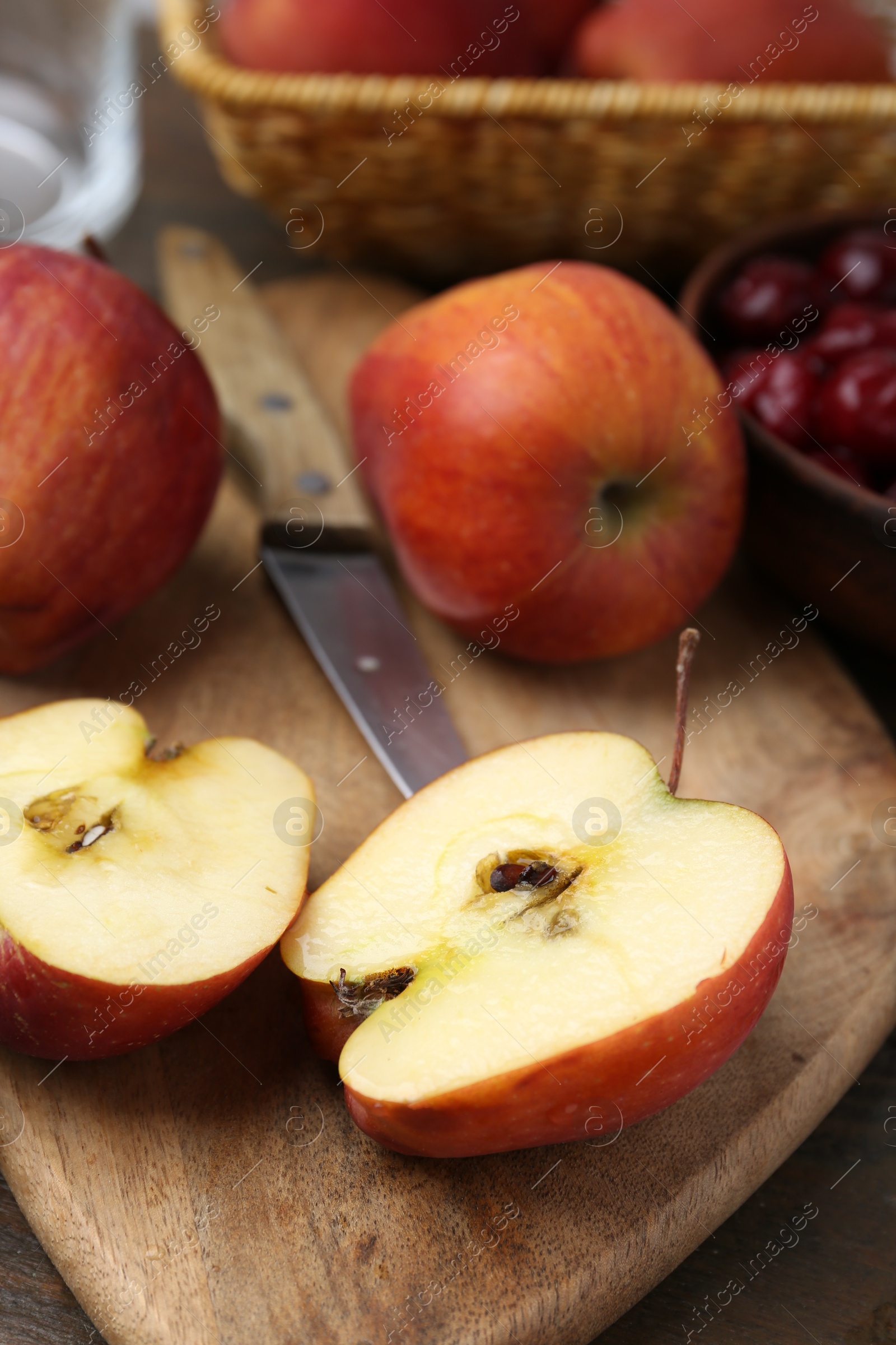 Photo of Apples and tasty cherries on wooden table, closeup