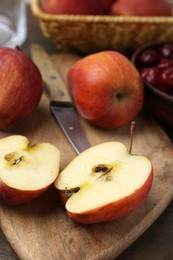 Photo of Apples and tasty cherries on wooden table, closeup