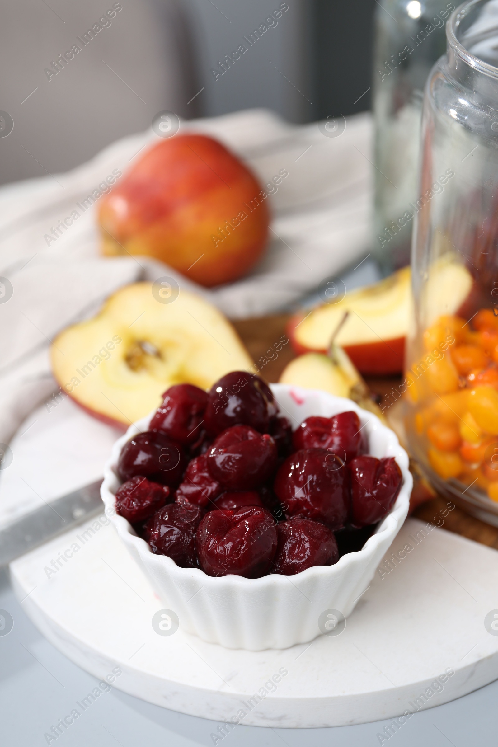 Tasty cherries, apples and sea buckthorn berries on light grey table, closeup Photo of Tasty cherries, apples and sea buckthorn berries on light grey table, closeup