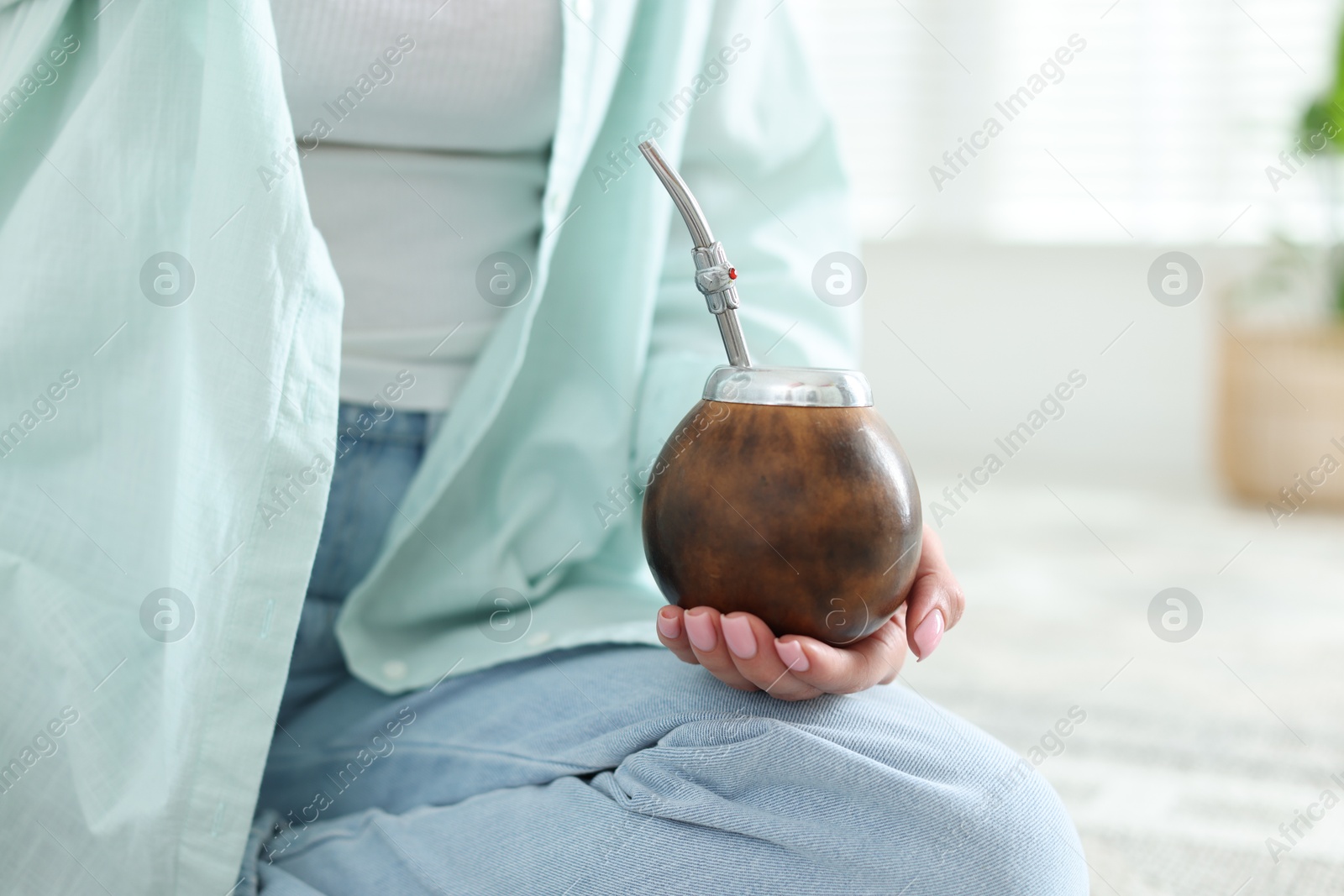Woman with traditional yerba mate tea at home, closeup. Space for text Photo of Woman with traditional yerba mate tea at home, closeup. Space for text