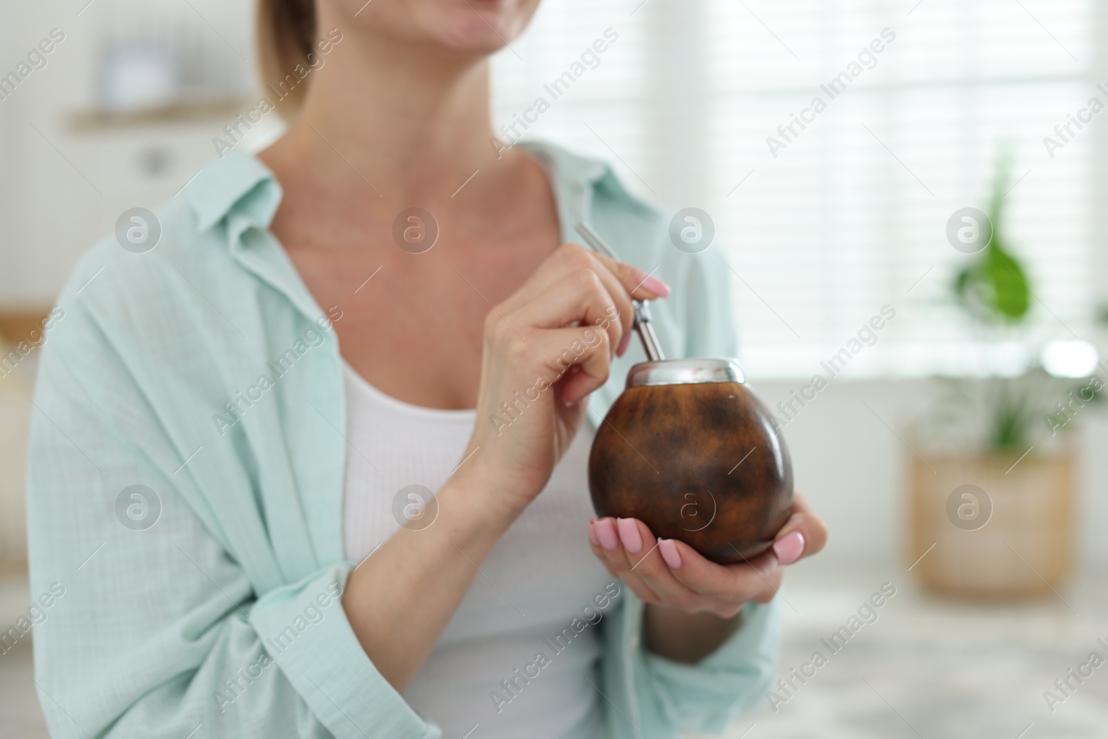 Woman with traditional yerba mate tea at home, closeup. Space for text Photo of Woman with traditional yerba mate tea at home, closeup. Space for text