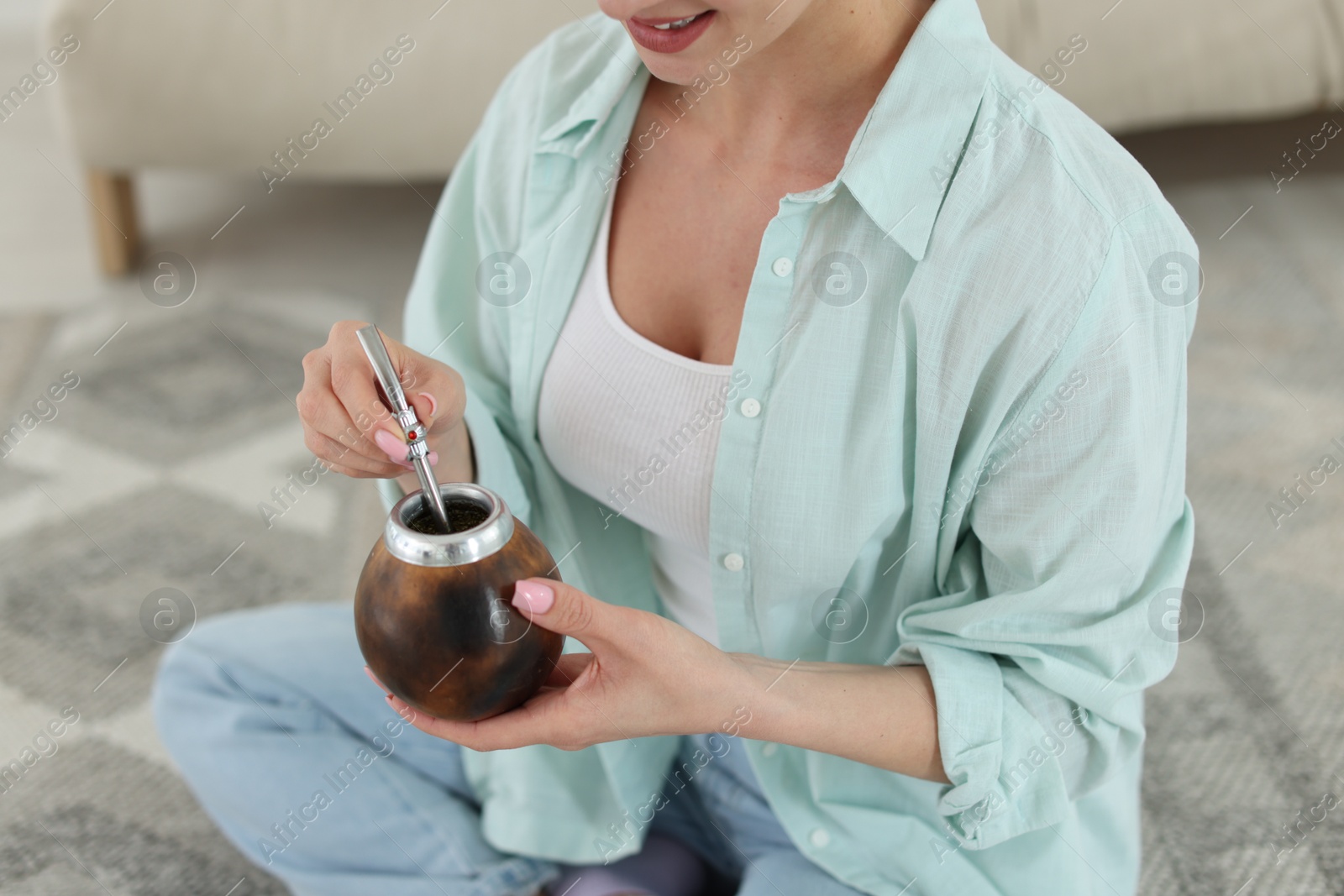 Woman with traditional yerba mate tea at home, closeup Photo of Woman with traditional yerba mate tea at home, closeup