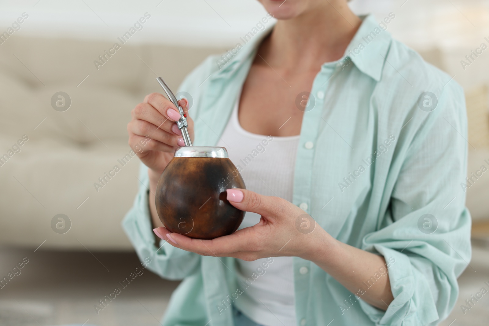 Woman with traditional yerba mate tea at home, closeup. Space for text Photo of Woman with traditional yerba mate tea at home, closeup. Space for text