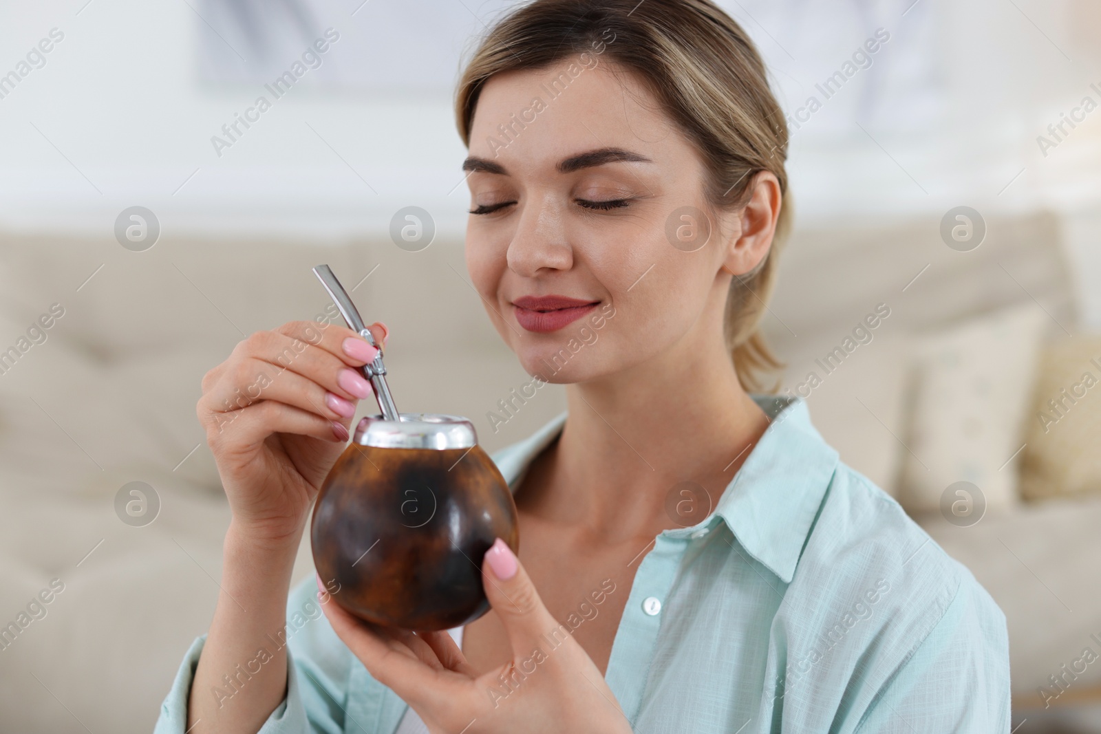 Woman with traditional yerba mate tea at home Photo of Woman with traditional yerba mate tea at home