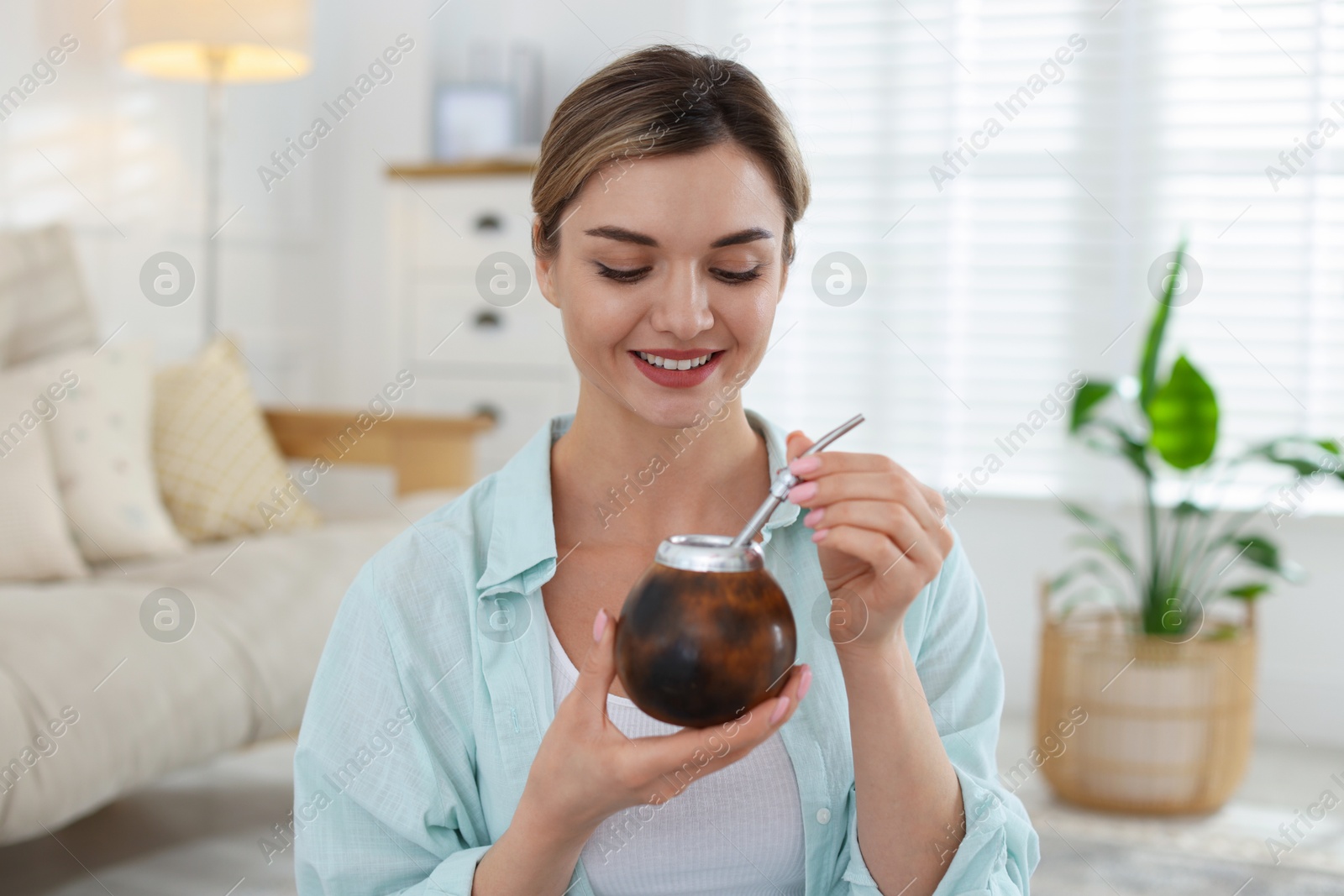 Woman with traditional yerba mate tea at home Photo of Woman with traditional yerba mate tea at home