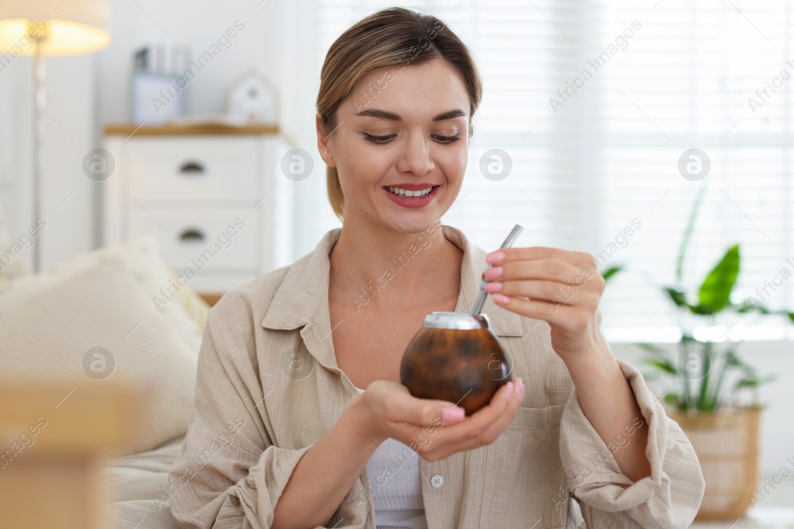 Woman with traditional yerba mate tea at home Photo of Woman with traditional yerba mate tea at home