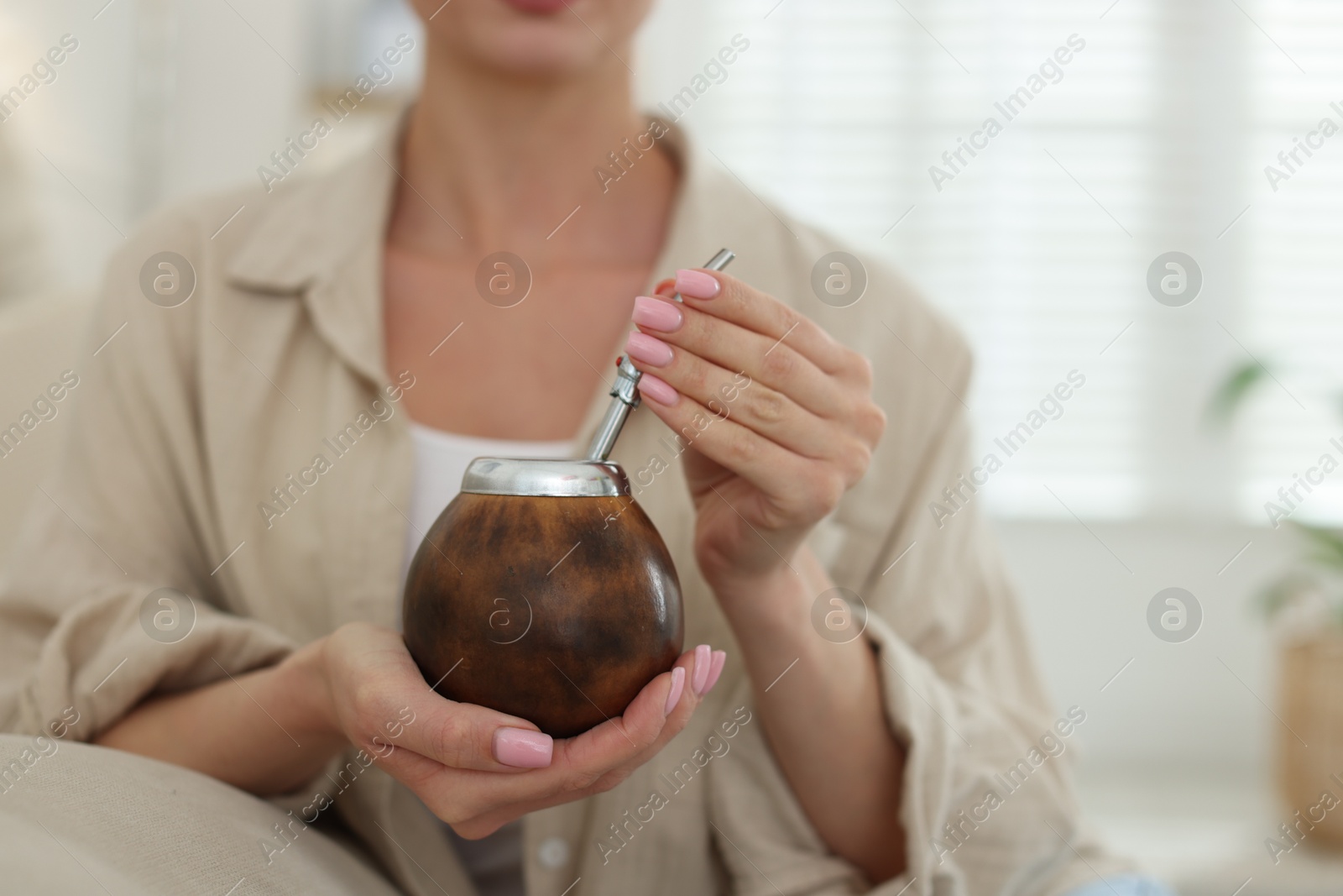 Woman with traditional yerba mate tea at home, closeup. Space for text Photo of Woman with traditional yerba mate tea at home, closeup. Space for text