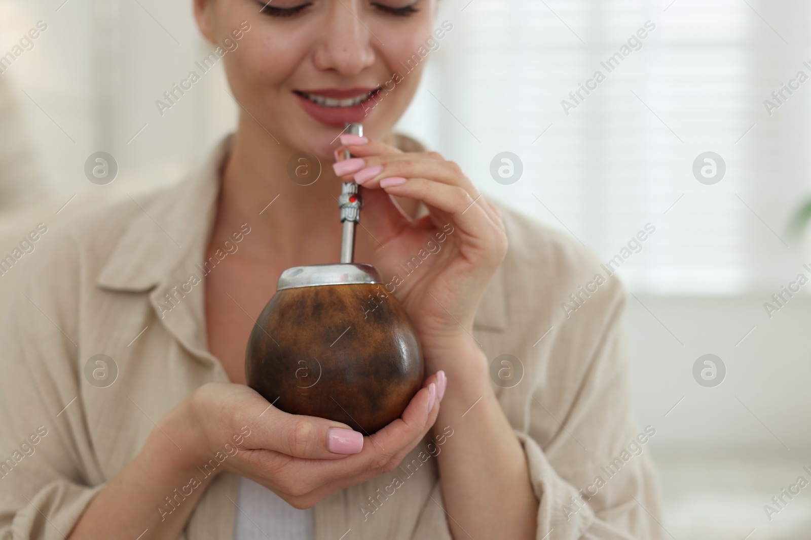 Woman with traditional yerba mate tea at home, closeup Photo of Woman with traditional yerba mate tea at home, closeup