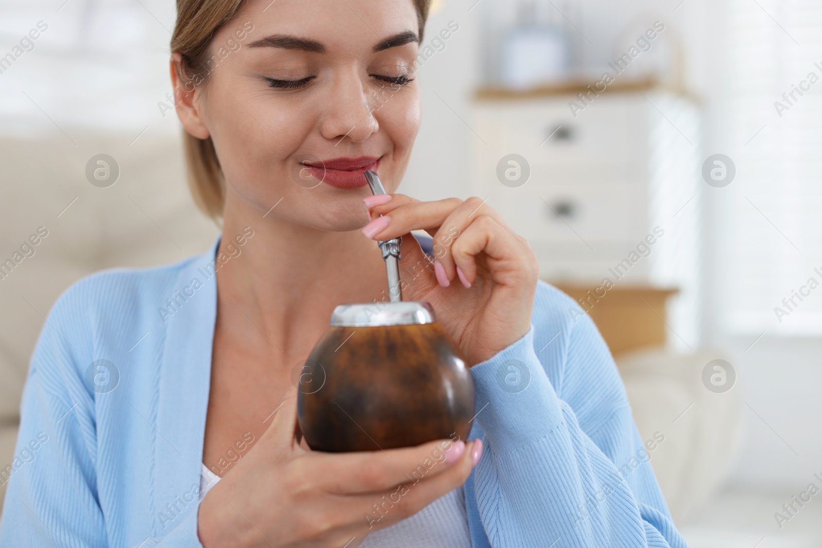 Woman with traditional yerba mate tea at home Photo of Woman with traditional yerba mate tea at home