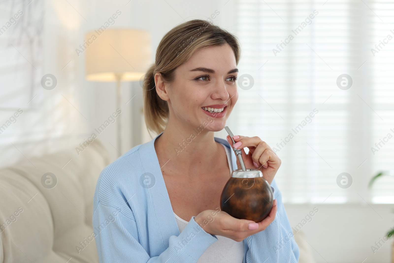 Woman with traditional yerba mate tea at home Photo of Woman with traditional yerba mate tea at home