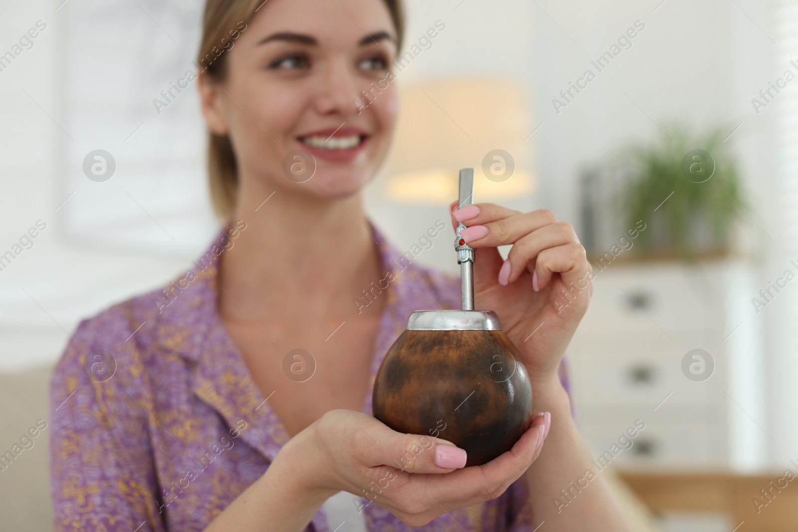 Woman with traditional yerba mate tea at home, selective focus Photo of Woman with traditional yerba mate tea at home, selective focus