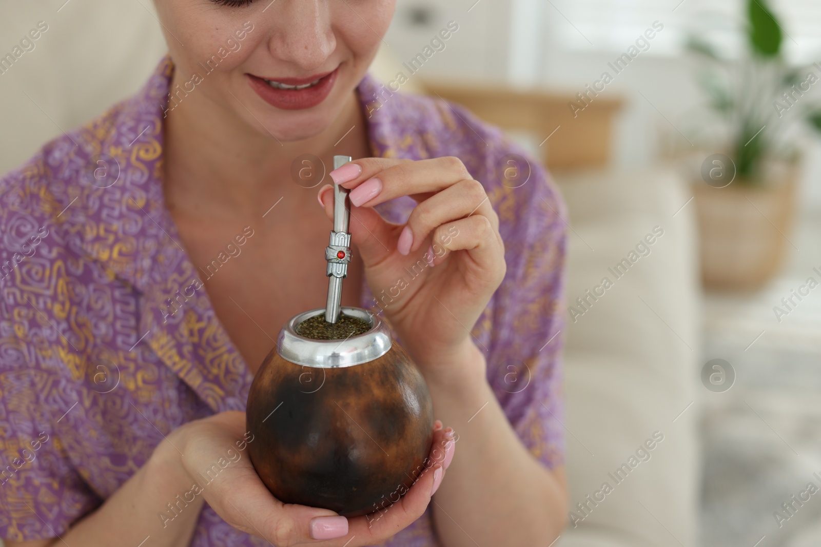 Woman with traditional yerba mate tea at home, closeup. Space for text Photo of Woman with traditional yerba mate tea at home, closeup. Space for text