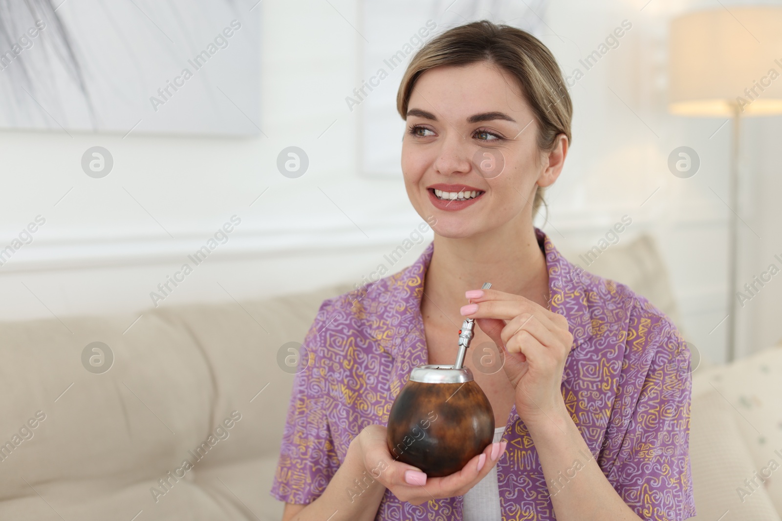 Woman with traditional yerba mate tea at home, space for text Photo of Woman with traditional yerba mate tea at home, space for text