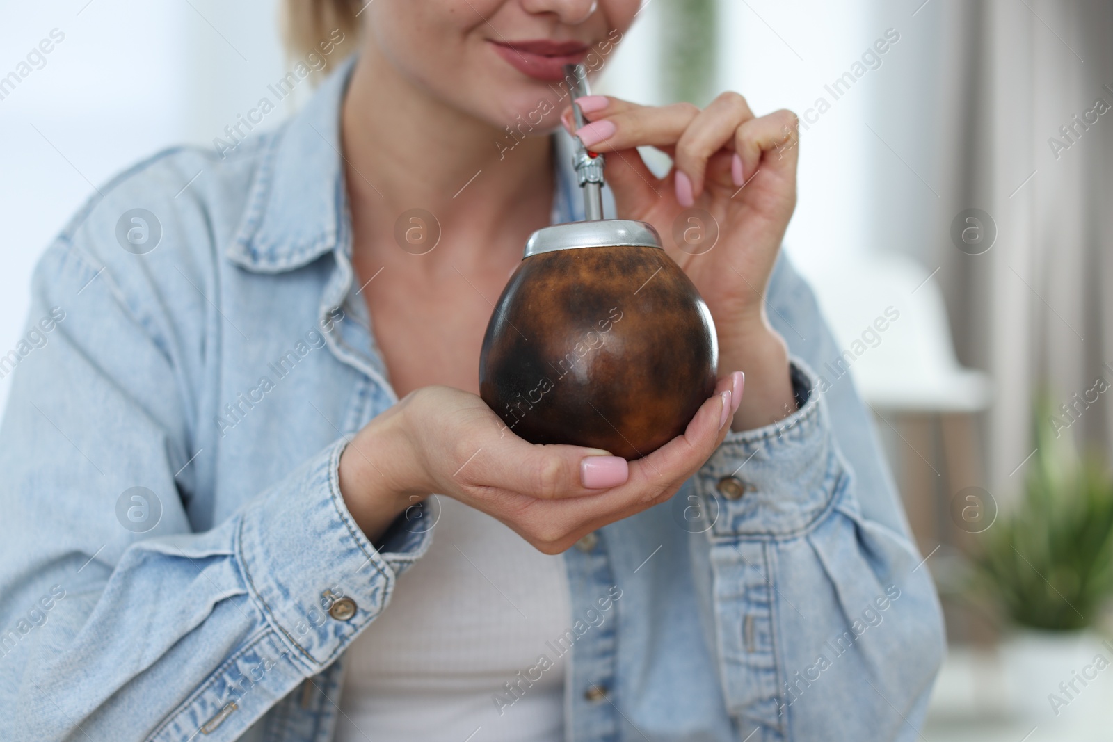 Woman drinking traditional yerba mate tea at home, closeup Photo of Woman drinking traditional yerba mate tea at home, closeup