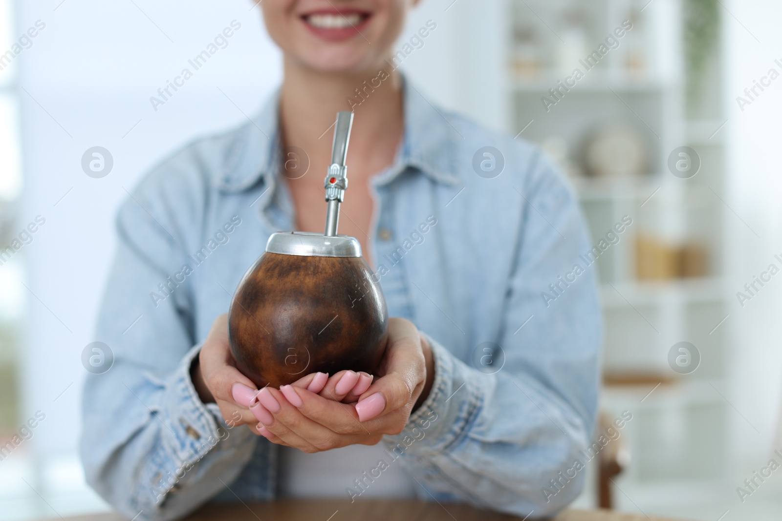Woman with traditional yerba mate tea indoors, closeup Photo of Woman with traditional yerba mate tea indoors, closeup