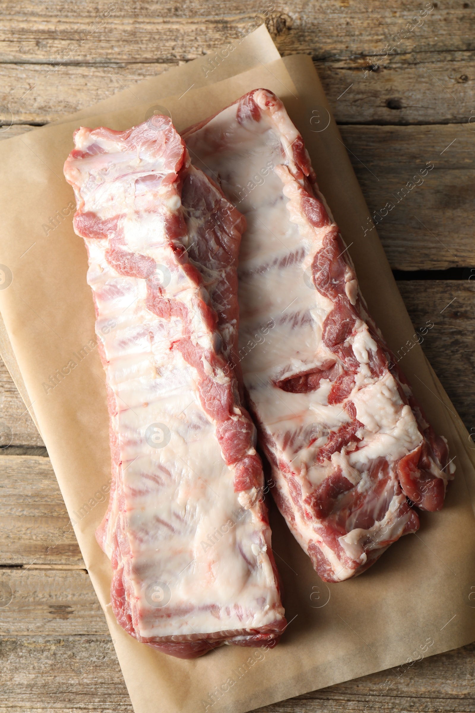 Raw pork ribs on wooden table, top view Photo of Raw pork ribs on wooden table, top view