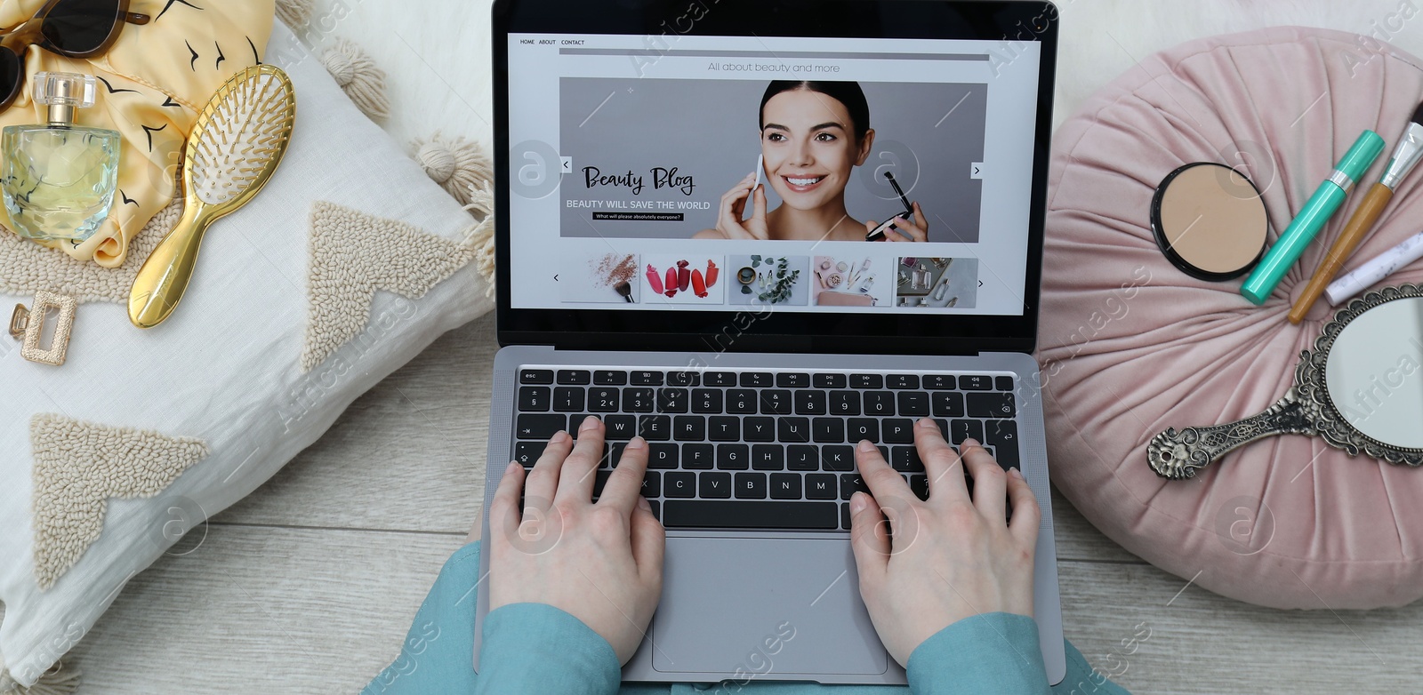 Blogger using laptop with beauty blog web site on floor indoors, above view Photo of Blogger using laptop with beauty blog web site on floor indoors, above view