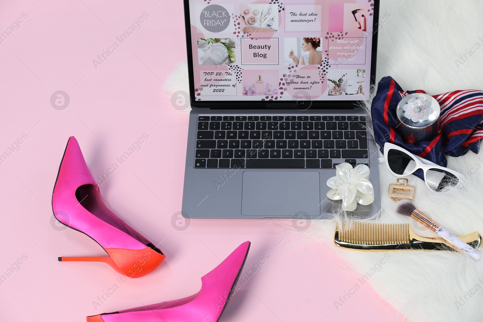 Laptop with beauty blog web site, shoes and different accessories on pink background, above view Photo of Laptop with beauty blog web site, shoes and different accessories on pink background, above view