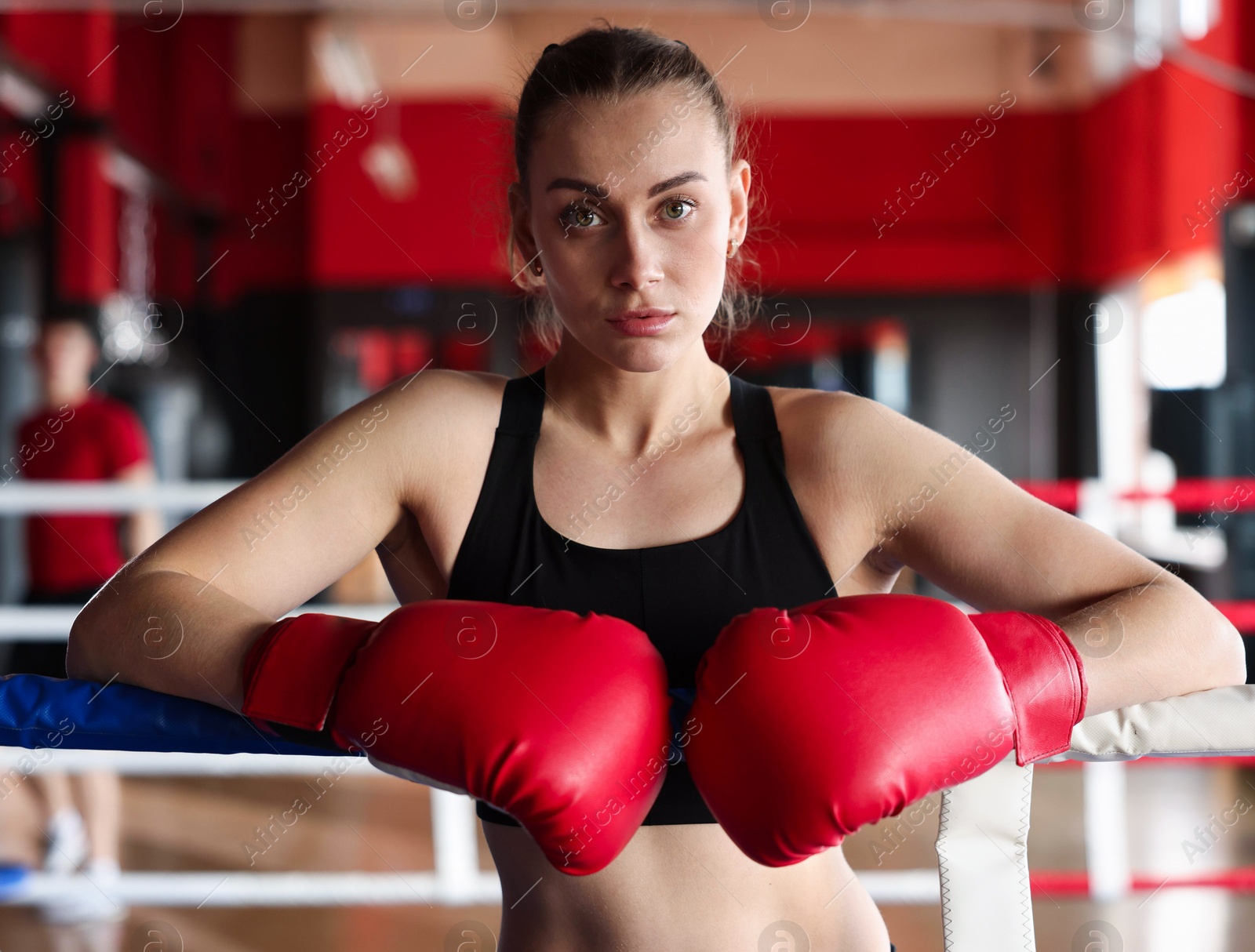 Woman with protective gloves on boxing ring Photo of Woman with protective gloves on boxing ring