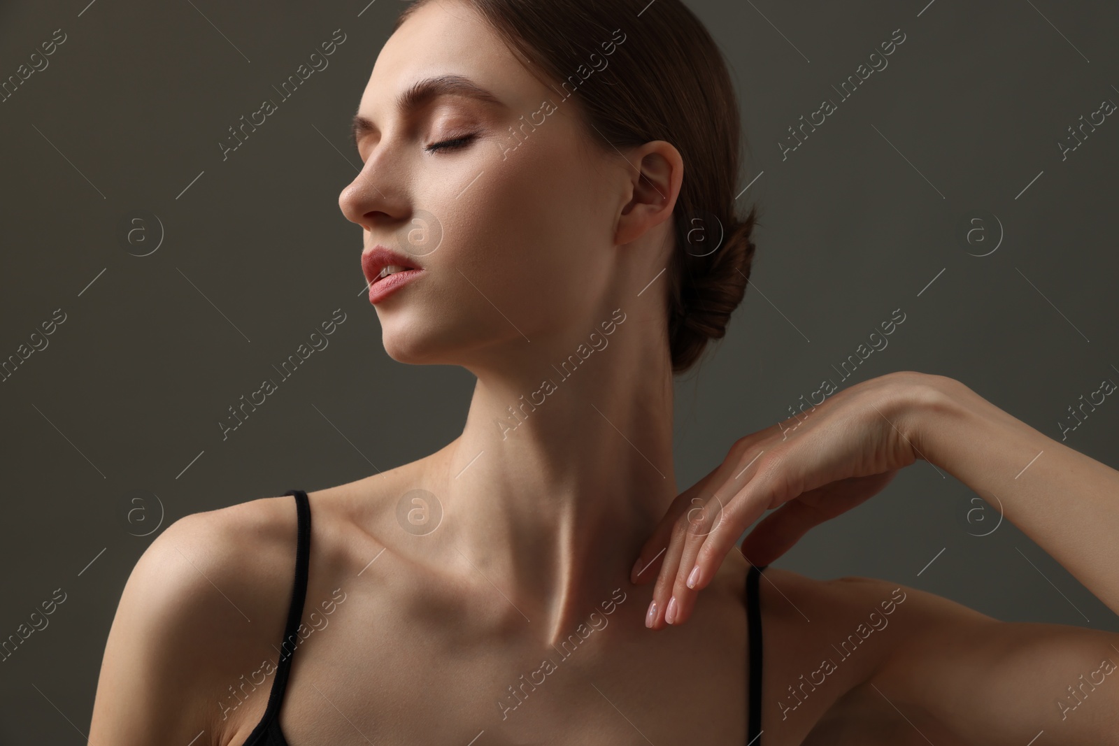 Beautiful woman with perfect skin on grey background Photo of Beautiful woman with perfect skin on grey background