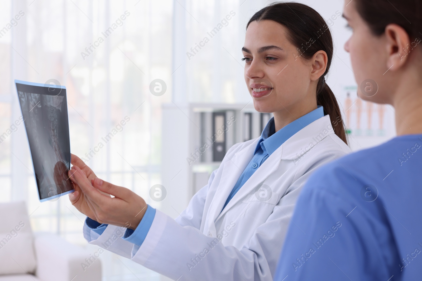 Doctor and nurse examining MRI scan in hospital, closeup Photo of Doctor and nurse examining MRI scan in hospital, closeup