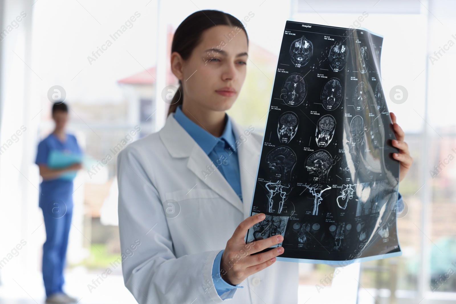 Doctor examining brain MRI scan in hospital Photo of Doctor examining brain MRI scan in hospital