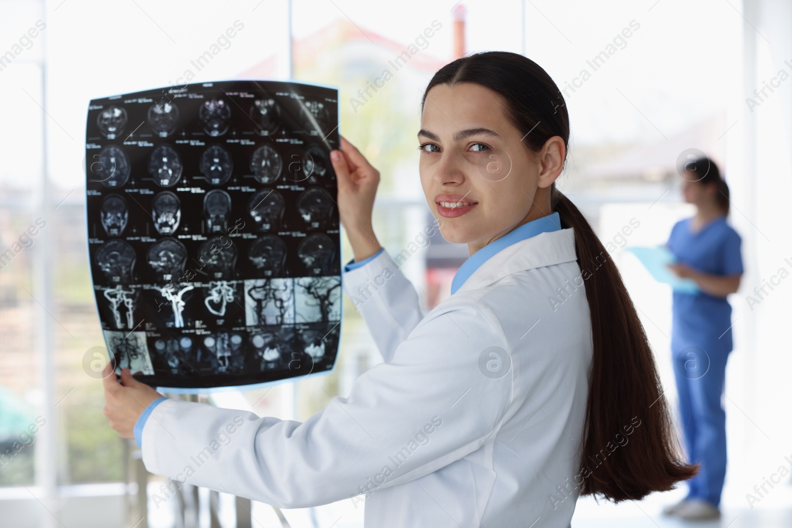 Doctor examining brain MRI scan in hospital Photo of Doctor examining brain MRI scan in hospital